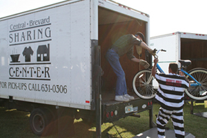 Inmate loading bikes for tykes into truck