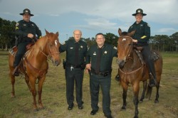 2 mounted posse on horses with sheriff