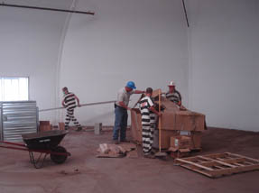 Tent shell has been erected and inmates help with interior construction.